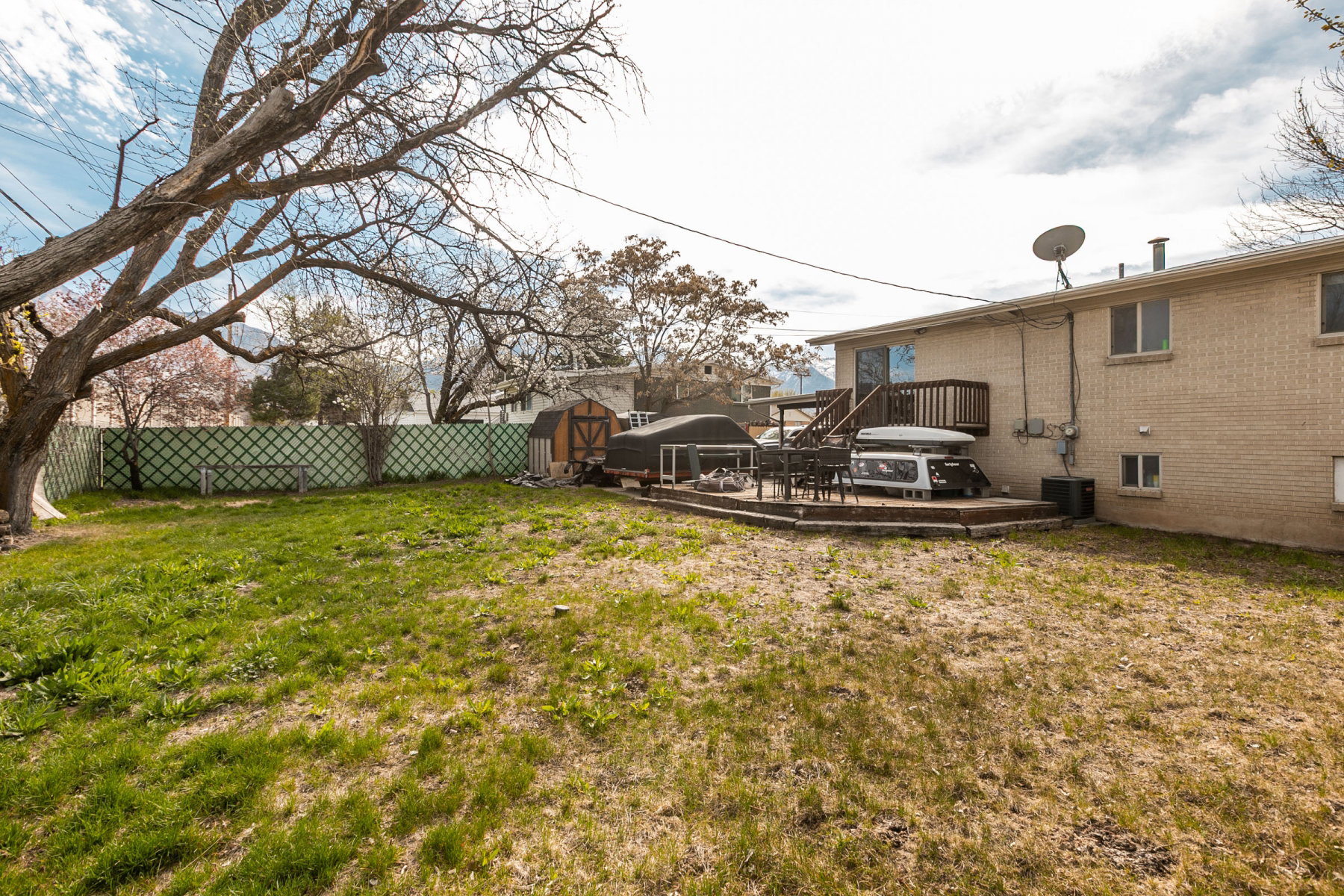 Fenced backyard with a patio area and a shed