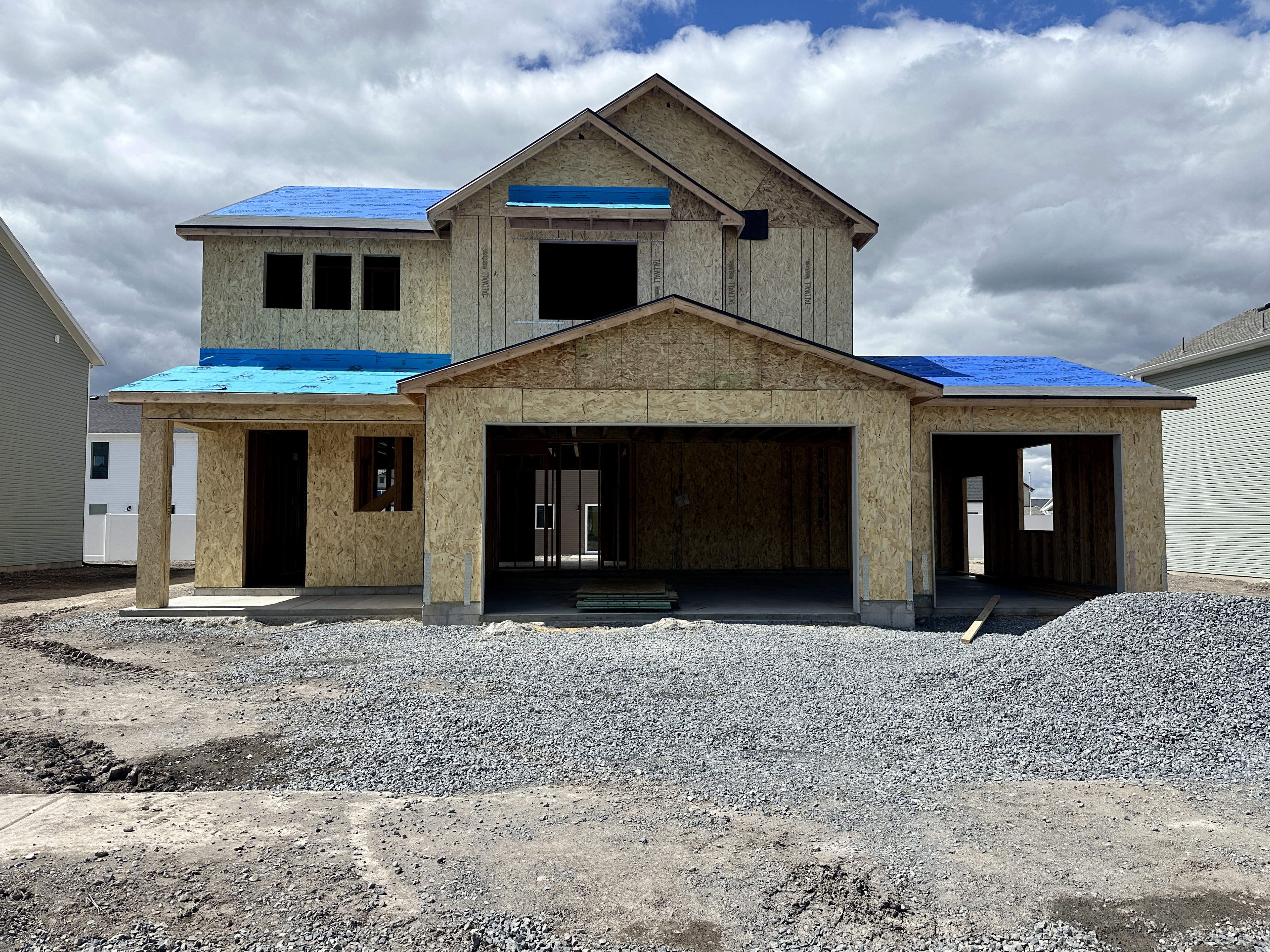 View of front facade with a porch and stucco siding
