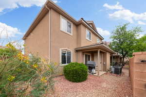 Rear view of property with stucco siding and a patio area