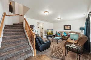 Tiled living area featuring stairway and a textured ceiling