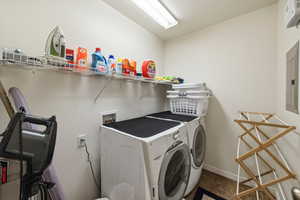 Laundry room with washing machine and dryer and electric panel