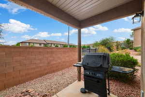 View of patio with area for grilling and a residential view