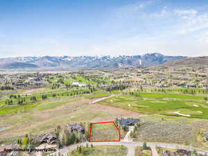 Aerial perspective of suburban area with property boundaries highlighted, a mountainous background, and a golf club