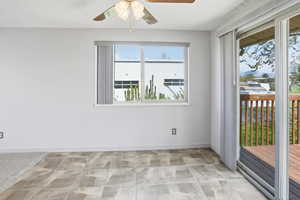 Unfurnished room featuring ceiling fan and baseboards