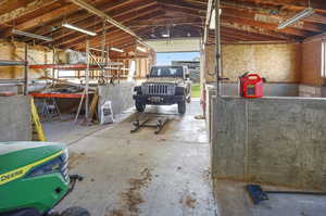 Miscellaneous room with a garage and concrete flooring