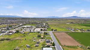 Overview of rural landscape featuring a mountainous background and extensive farmland