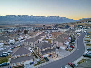 Aerial overview of property's location featuring a mountainous background and nearby suburban area