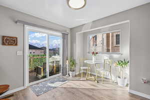Dining area with a mountain view and light wood-style floors
