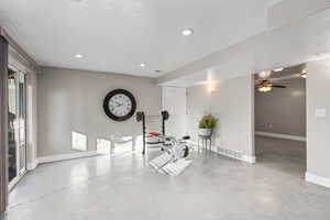 Exercise room featuring concrete flooring, recessed lighting, and ceiling fan