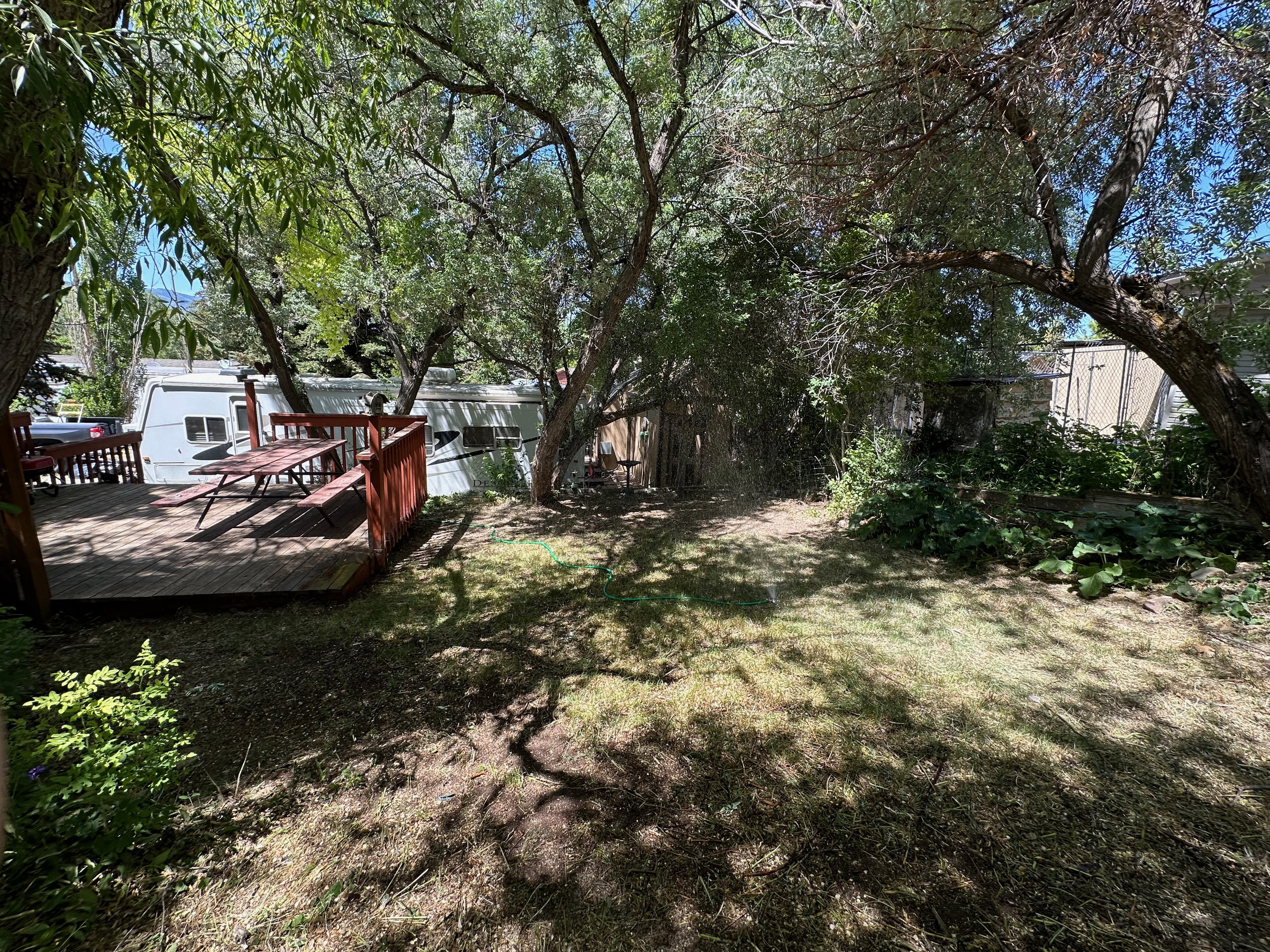 Expansive outdoor deck with wood railing and integrated picnic table