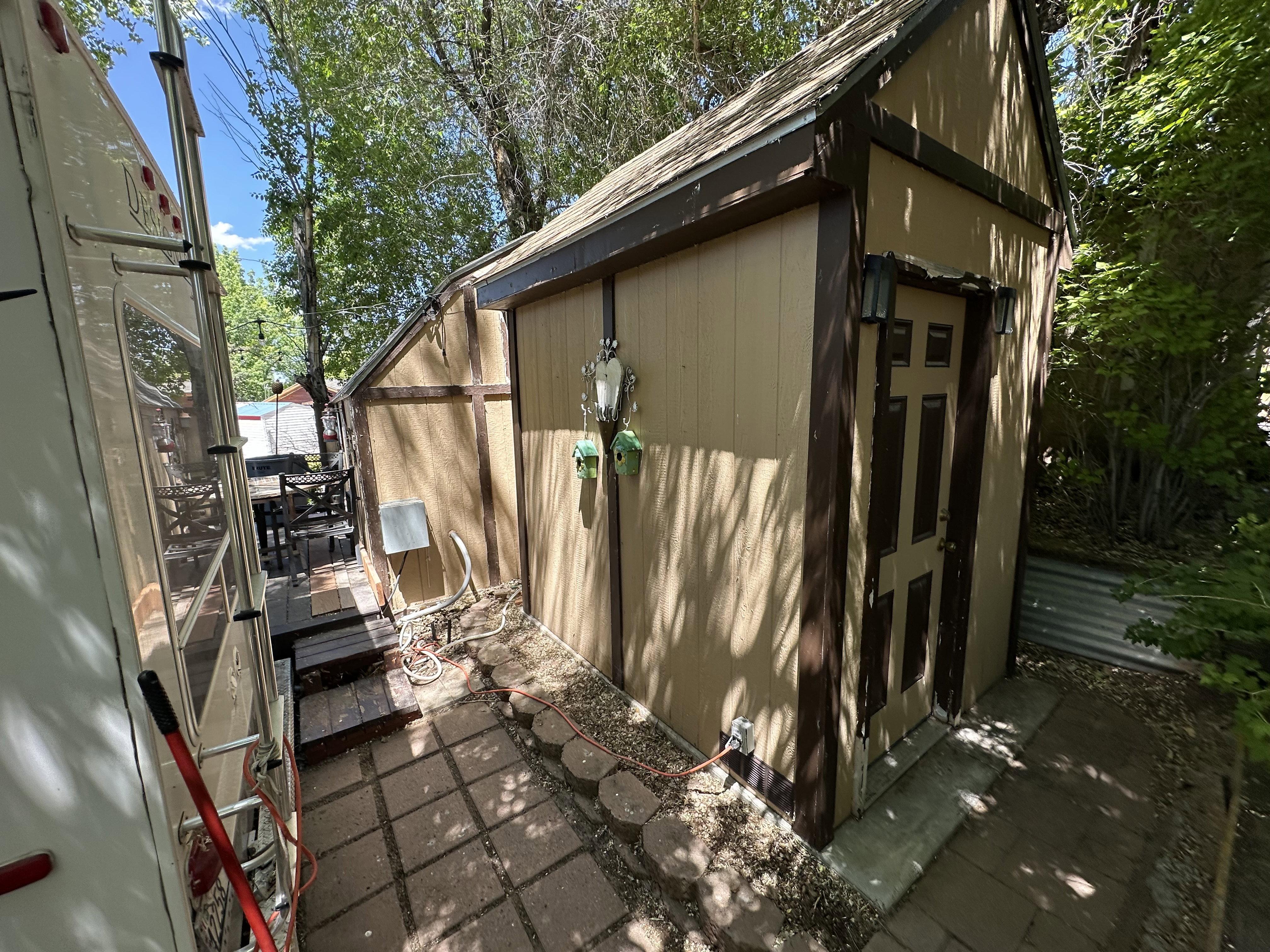 View of side of home with a shed