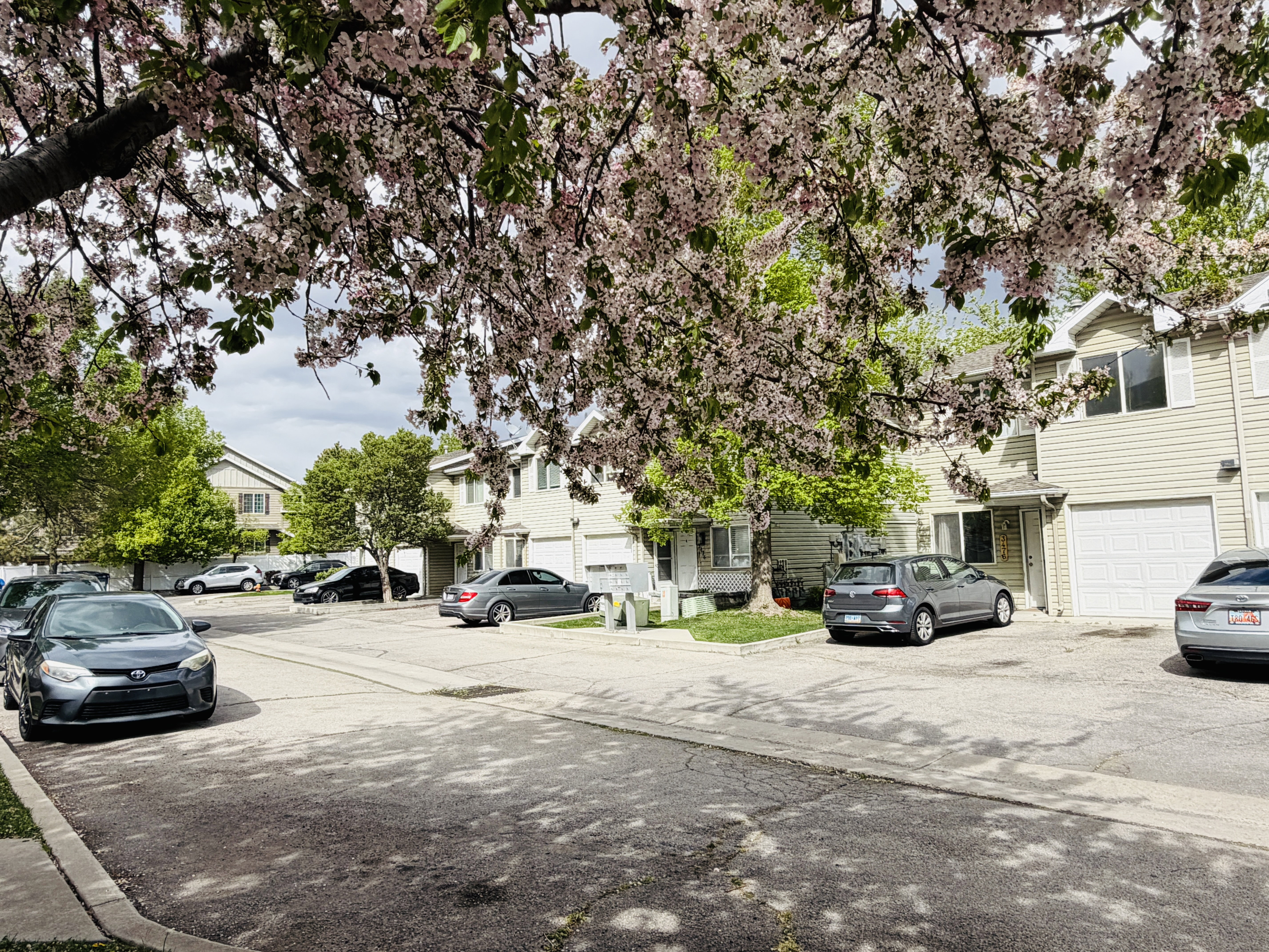 View of asphalt road with a residential view and curbs