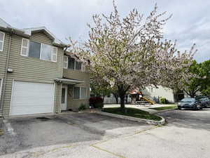 View of front of home featuring an attached garage and driveway