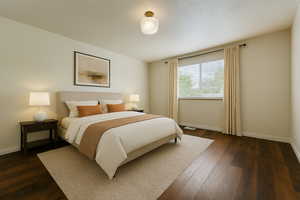 Bedroom with dark wood-type flooring