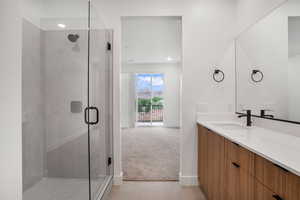 Full bath with vanity, a shower stall, light colored carpet, light tile patterned flooring, and recessed lighting
