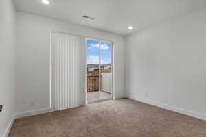 Carpeted spare room featuring baseboards and recessed lighting