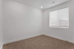 Spare room with carpet and recessed lighting