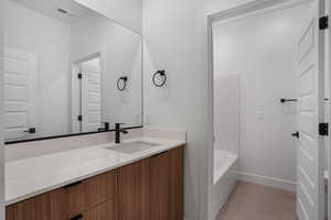Bathroom with vanity and light tile patterned flooring