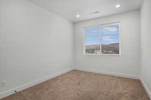 Spare room with carpet flooring and recessed lighting