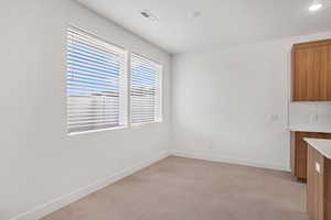 Unfurnished dining area with finished concrete flooring and recessed lighting