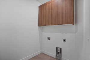 Laundry room with cabinet space, washer hookup, and hookup for an electric dryer