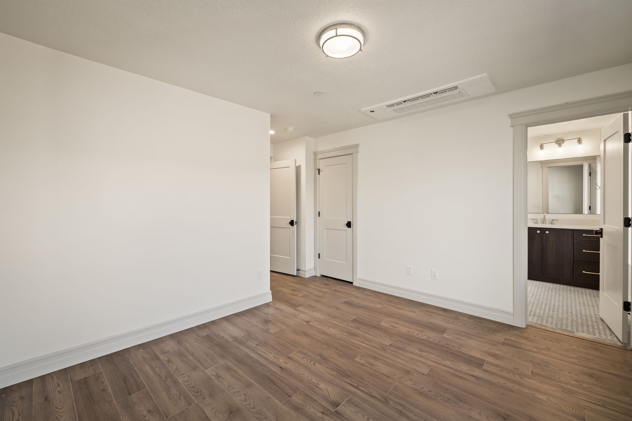 Pictures of an exterior unit -Empty room with dark wood-style floors and baseboards