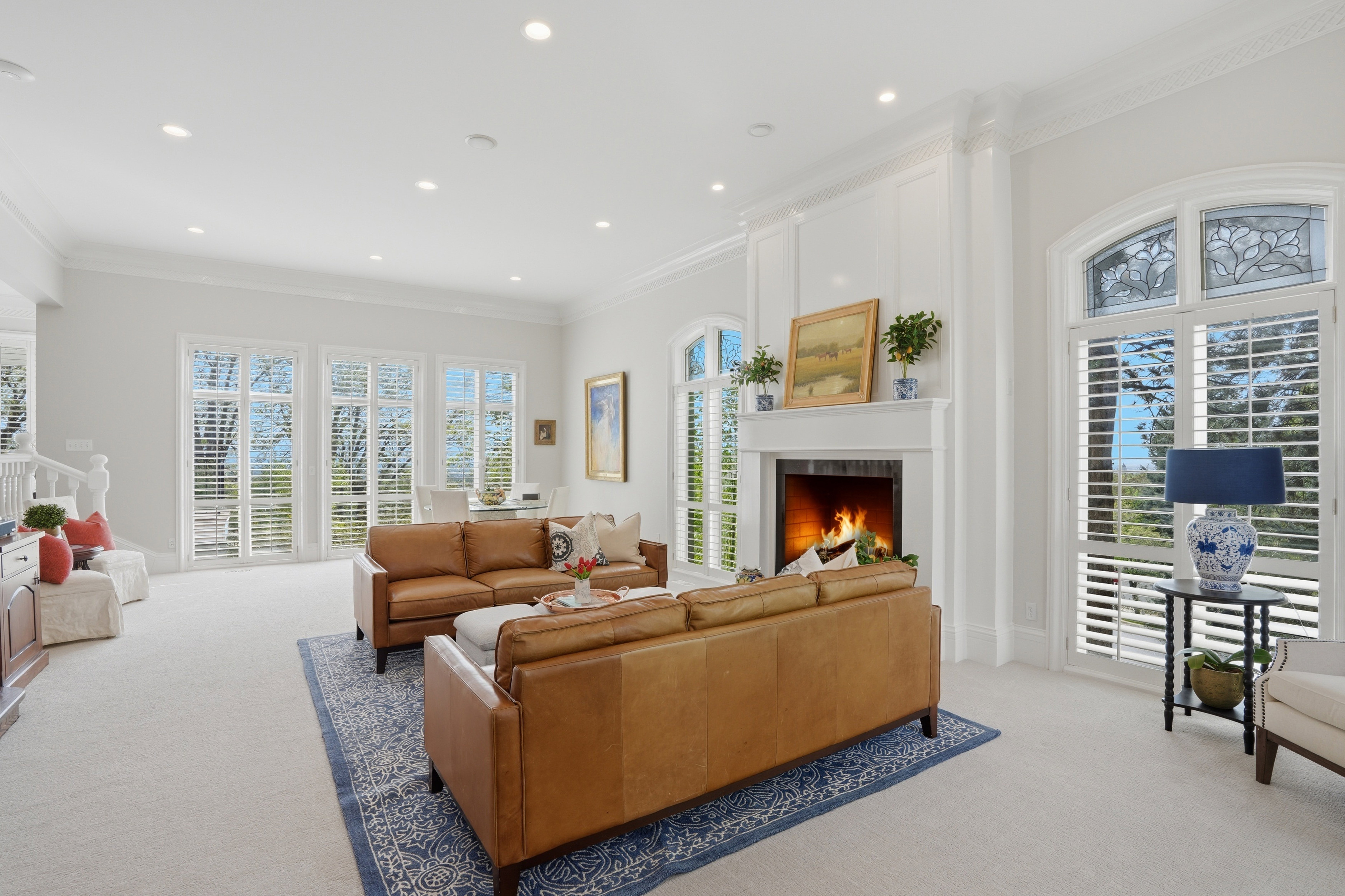 Living room with crown molding, custom paneling & natural light