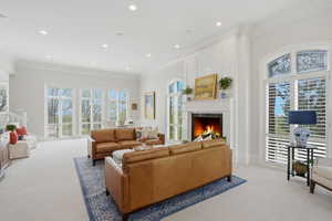 Living room with crown molding, custom paneling & natural light