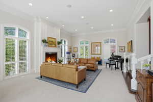 Living room with crown molding, custom paneling & natural light