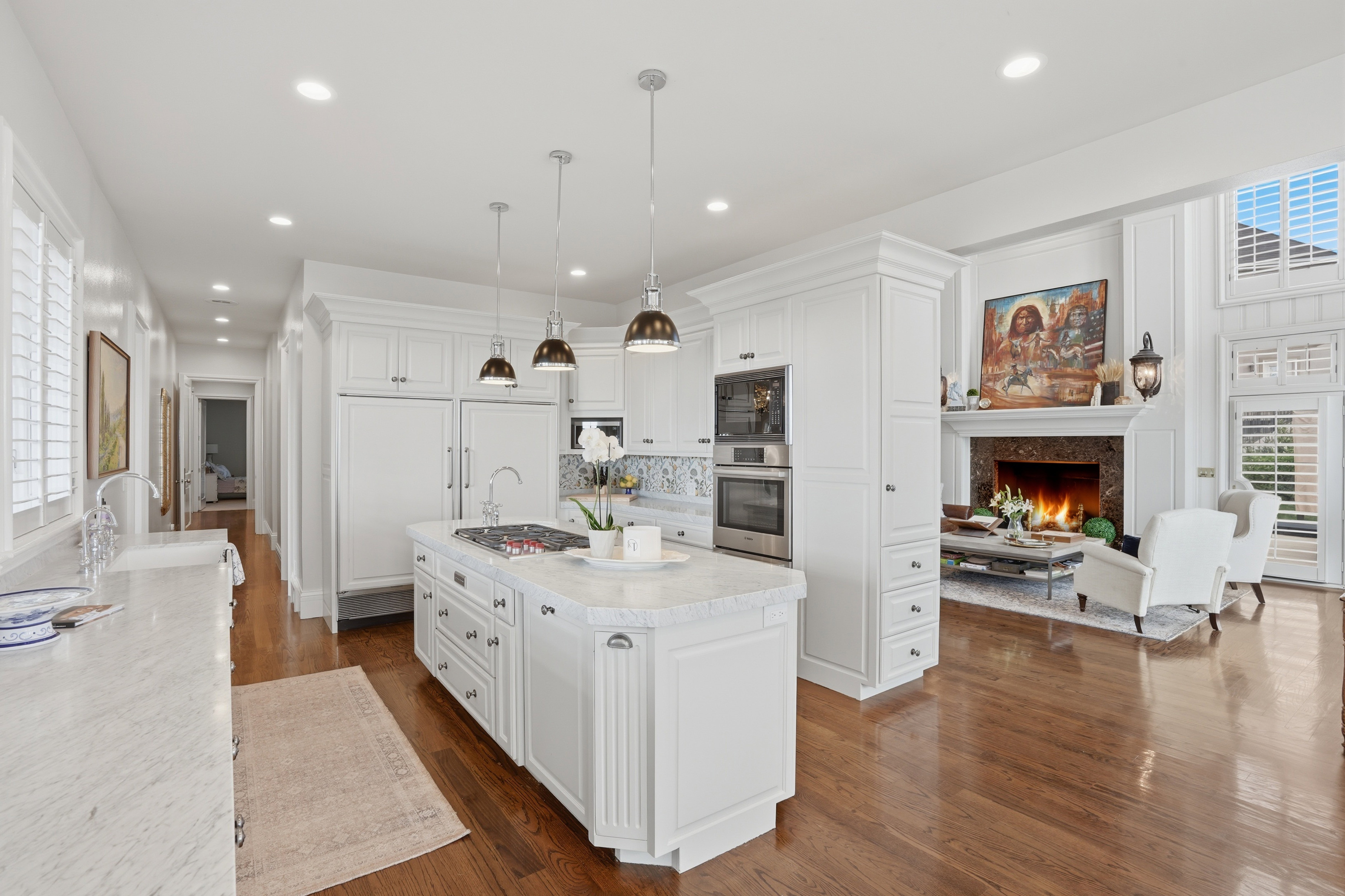 Updated kitchen with Carrara marble, new Wolf range, natural light