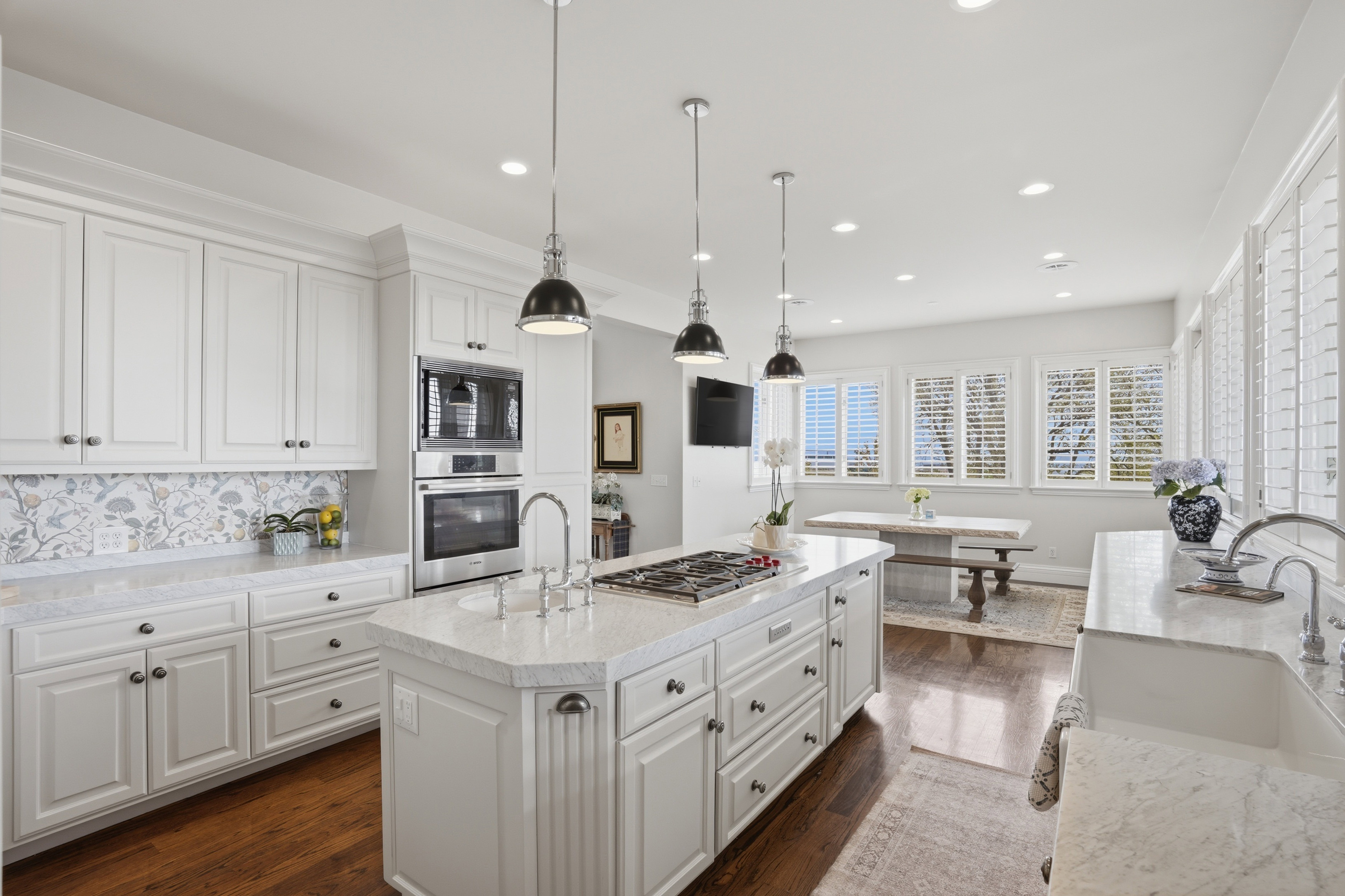 Updated kitchen with Carrara marble, new Wolf range, natural light