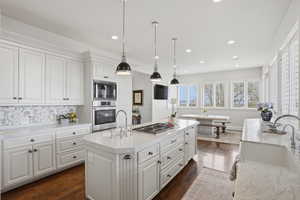 Updated kitchen with Carrara marble, new Wolf range, natural light