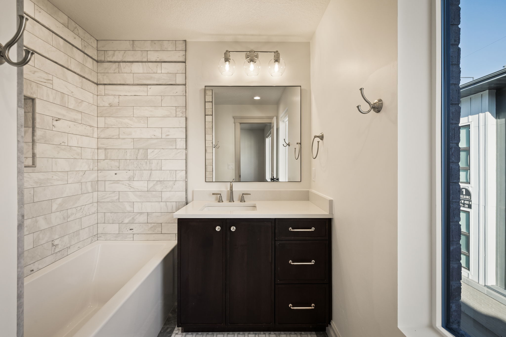 Photos of an exterior unit with the same finishes -Full bathroom with vanity and  shower combination