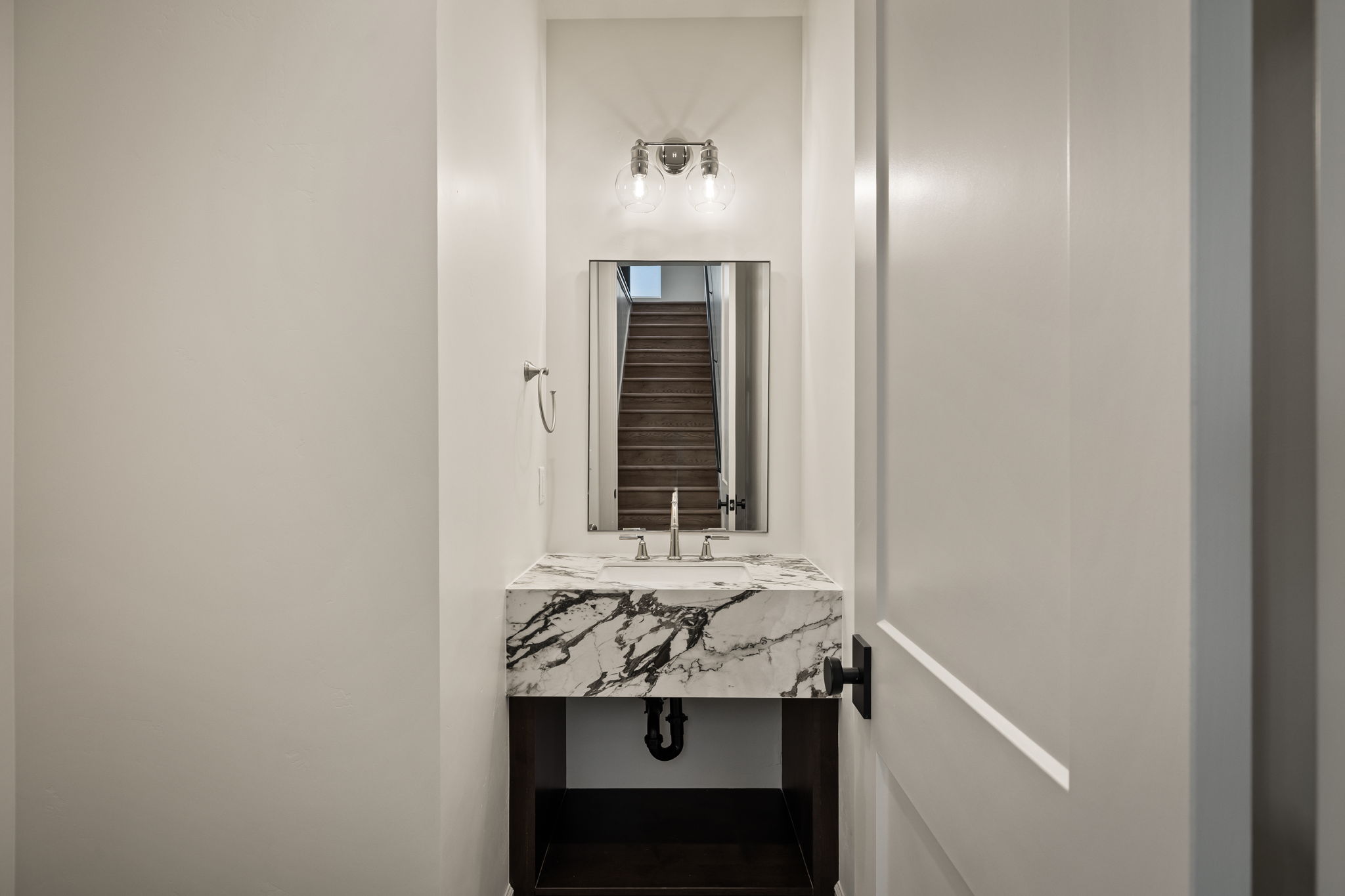 Photos of an exterior unit with the same finishes -Half bath with vanity