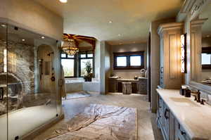 Bathroom with vanity, a garden tub, a marble finish shower, a chandelier, and light tile patterned floors