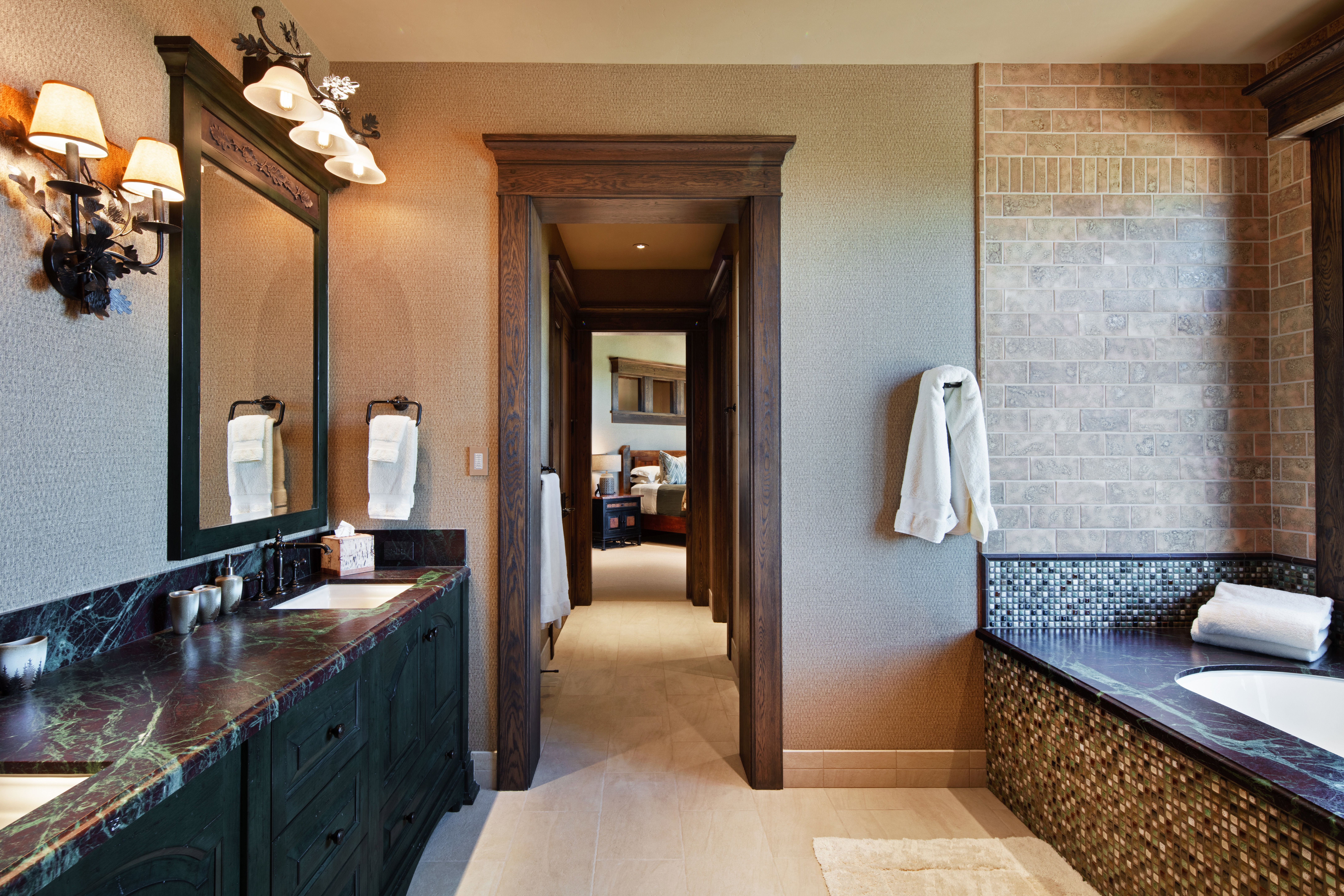 Full bath with a bath, double vanity, and light tile patterned floors