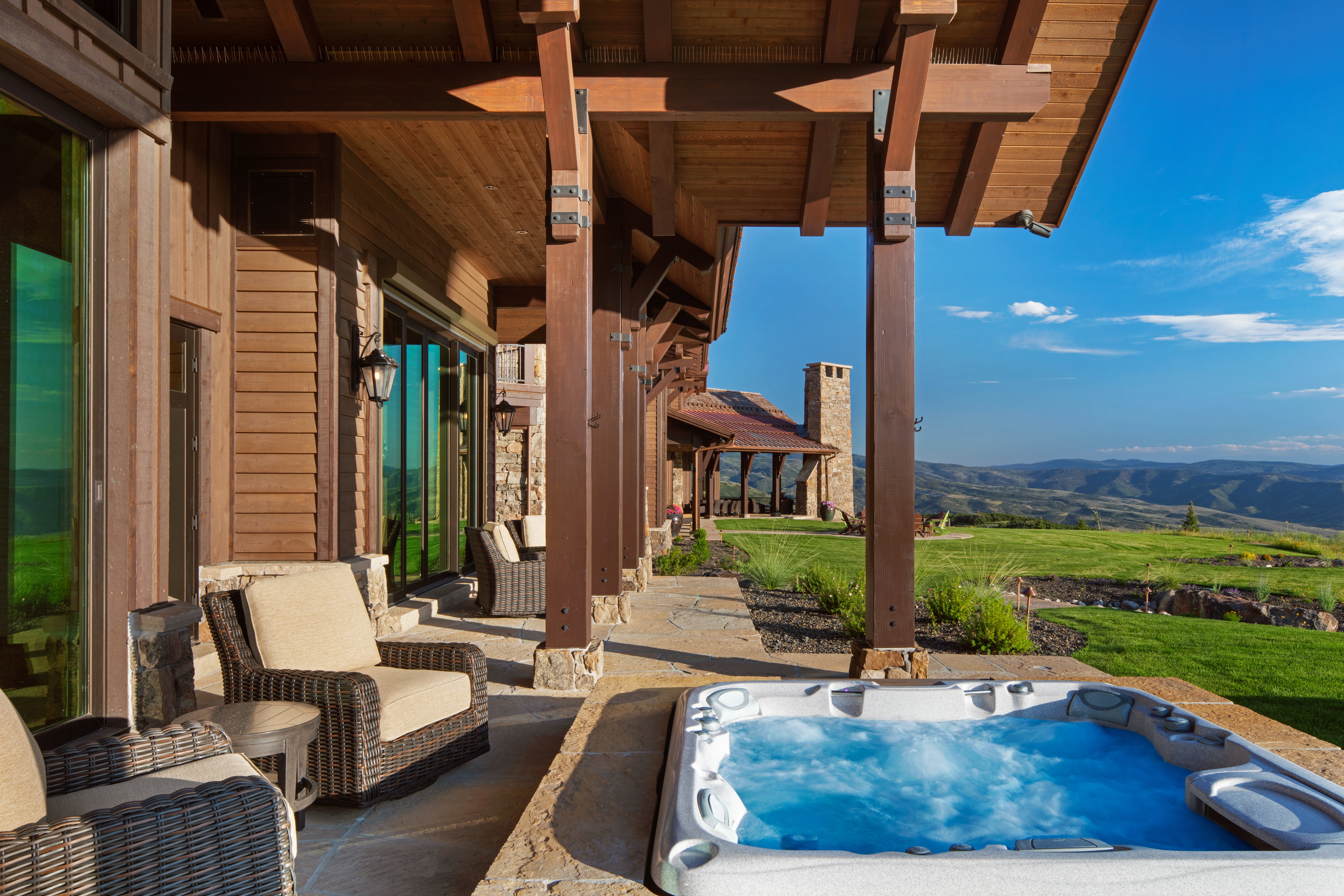 View of patio / terrace featuring a mountain view and an outdoor hot tub
