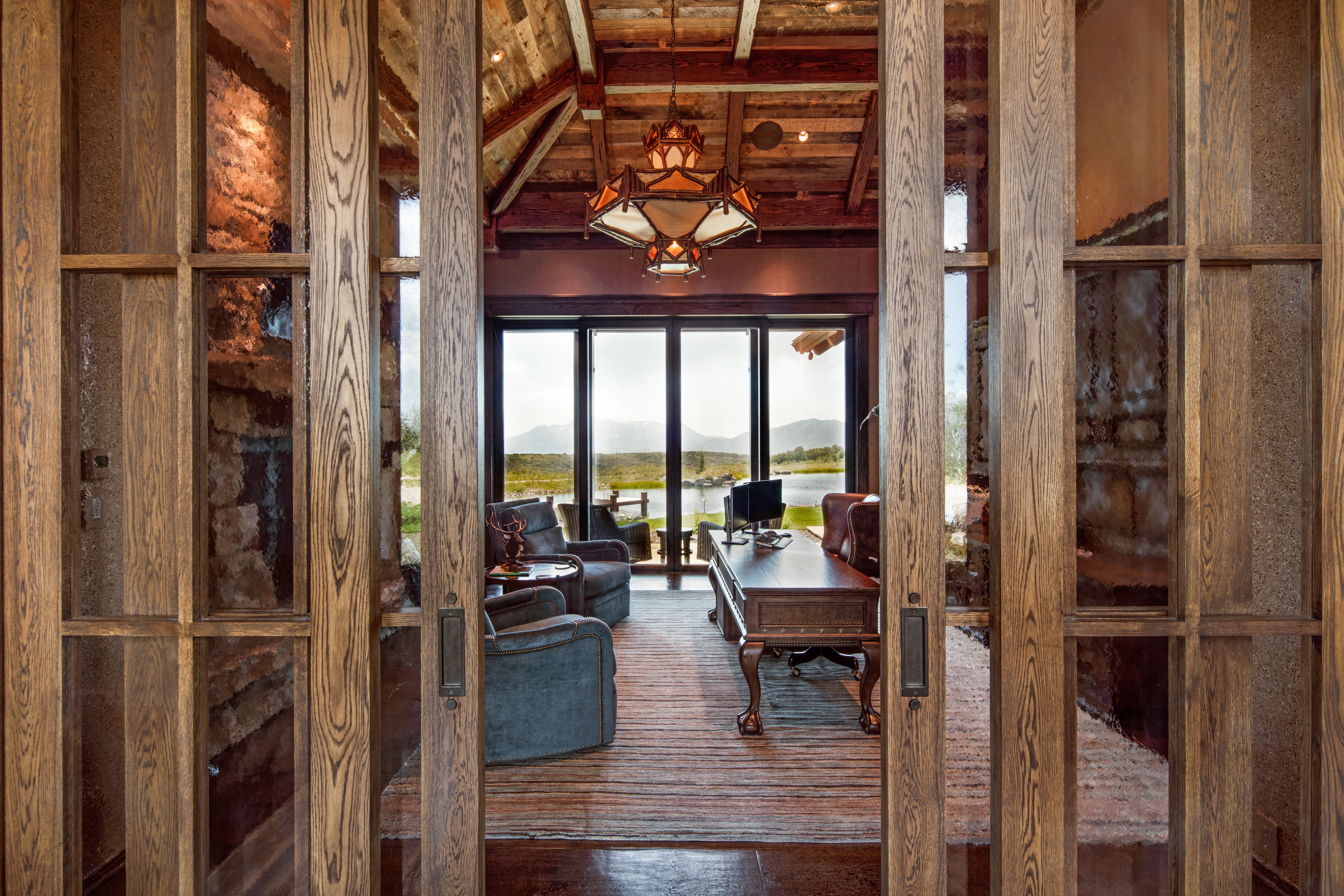Dining space with a mountain view and a wooden ceiling with exposed beams