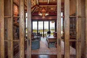 Dining space with a mountain view and a wooden ceiling with exposed beams