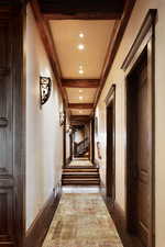 Hall with beamed ceiling and recessed lighting
