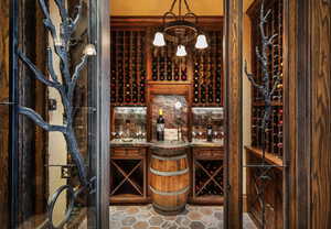 Wine room featuring suspended lighting