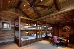 Carpeted bedroom with recessed lighting and a high wood beamed ceiling