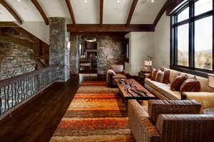 Living room featuring dark wood-type flooring and beamed ceiling