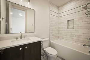Bathroom featuring vanity and  shower combination