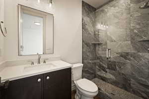 Full bathroom with vanity and a marble finish shower