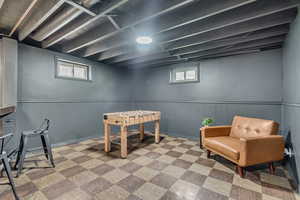 Playroom featuring light flooring and a wainscoted wall