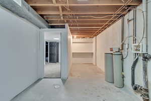 Unfinished below grade area with a water softener