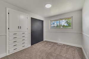Unfurnished bedroom featuring carpet flooring and baseboards