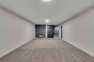Unfurnished living room with light carpet and a fireplace