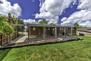 Back of property featuring brick siding and a patio area